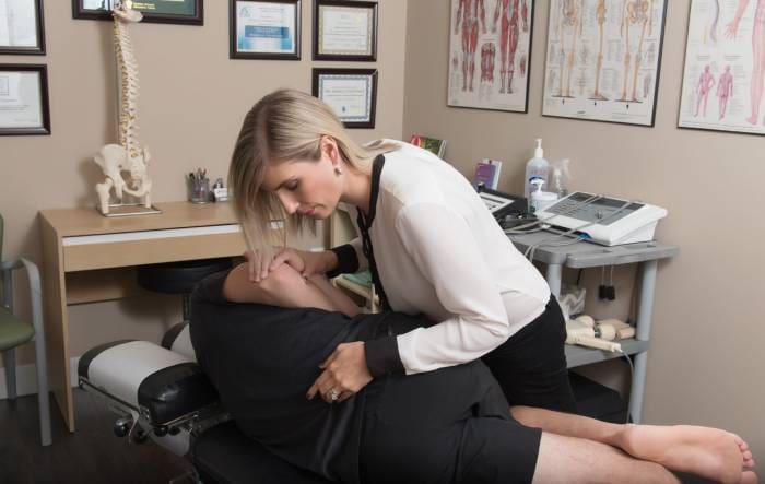 a woman is getting a massage in a medical office