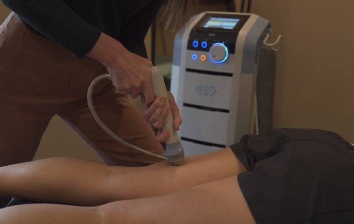 a woman is getting a massage on her leg