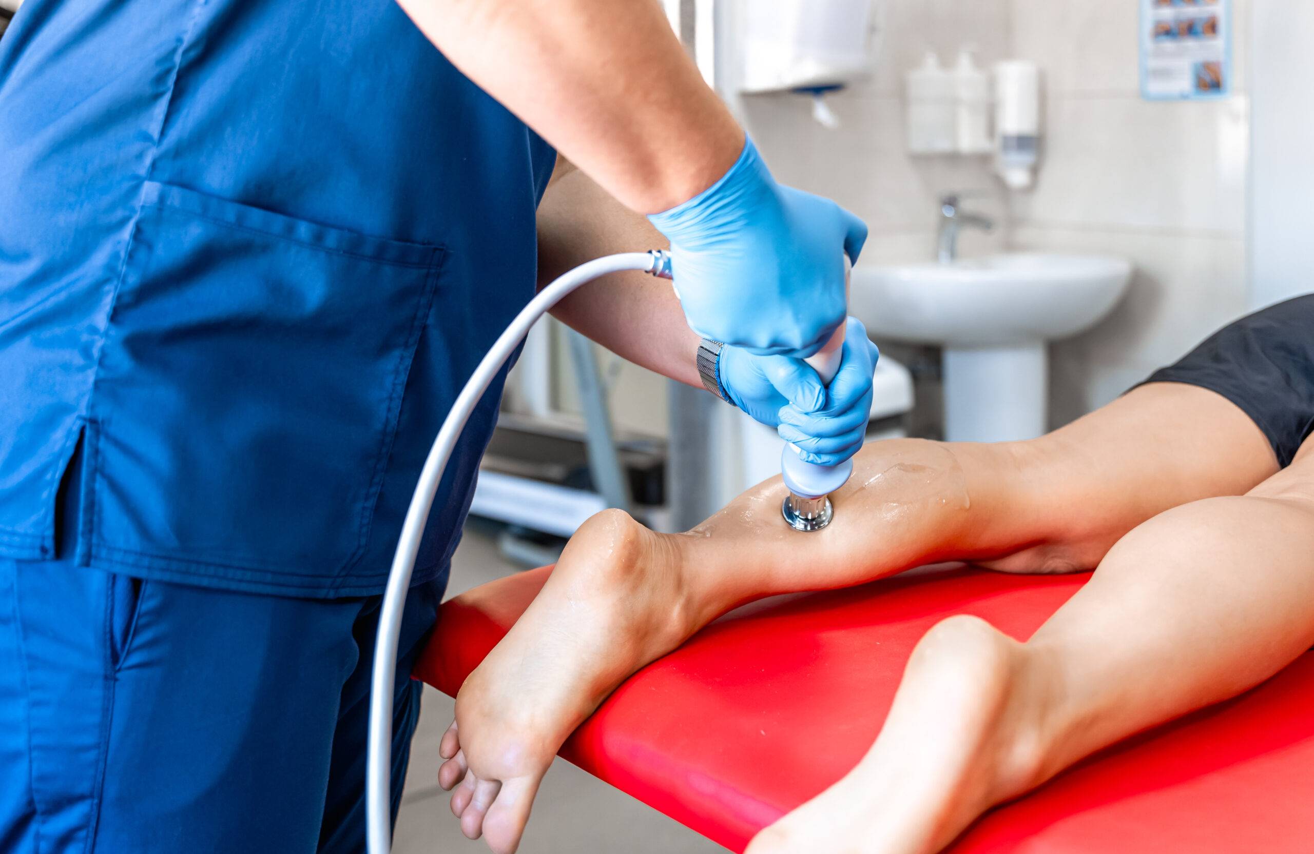 Woman rolling spiked ball under her feet in physical therapy